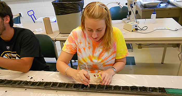 Liz George working with samples in a lab